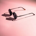 black framed sunglasses on white surface