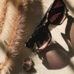 black framed sunglasses on white and black textile